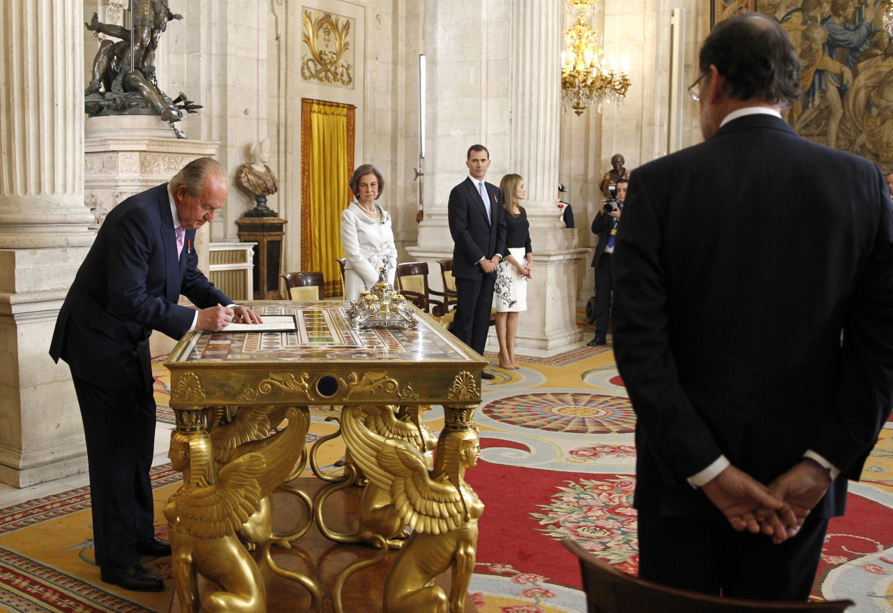 <p>Крал Хуан Карлос подписва документите за абдикацията си през 2014 г.</p>