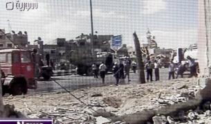Кадър на Сириската ТВ от мястото на атентата миналата година