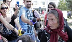 Възрастна жена от ромски произход, изгонена от Лион, се бори с румънските медии при пристигането си на летището в Букурещ