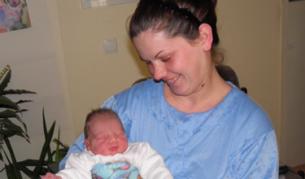 Малката Василена Самарова, родена една минута след настъпването на Новата година, си почива в обятията на майка й